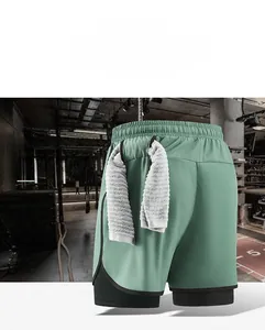 Detail of 2-in-1 sports shorts showing the back waist towel loop in a gym setting