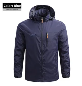 Detail of navy blue outdoor jacket showing hood and mountain logo embroidery on chest