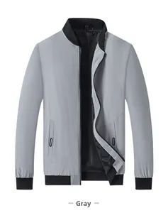 Detail of grey men's stand collar jacket with black ribbed knit collar and zippered pockets