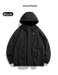 Detail of black hooded windbreaker jacket with tactical pockets and velcro sleeve cuffs