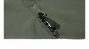 Detail of army green outdoor jacket featuring a secure zipper pocket with SPORTS engraving