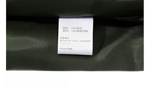 Detail view of the product wash label showing 100% nylon fabric and polyester lining