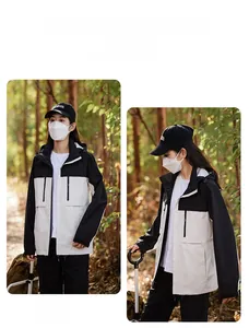 Detail of windproof hooded outdoor jacket with contrast black and white color block design