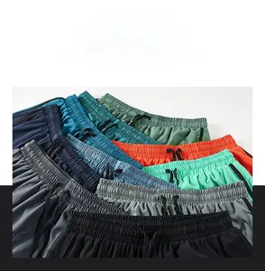 Detail of multi-color quick-dry shorts with elastic waistband and black drawstrings
