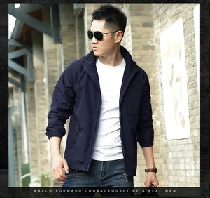 Detail of dark blue windproof outdoor jacket for men with a hood and high-density fabric