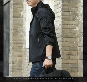 Detail of men's outdoor jacket showing sleeve badge and adjustable velcro cuffs