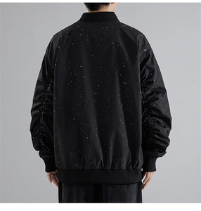 Detail of black bomber jacket featuring white starry pattern on back and ribbed cuffs