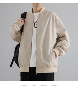 Detailed close-up of ribbed cuffs and metal zipper on this beige bomber jacket