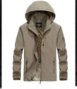 Detail of khaki outdoor jacket featuring functional zip pockets and breathable mesh lining