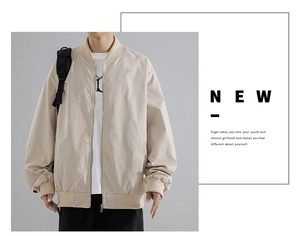 Detail view of khaki bomber jacket featuring ribbed collar and decorative shoulder strap
