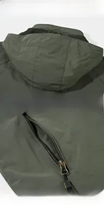 Detail display of olive green windbreaker showing hooded collar and zipper pockets