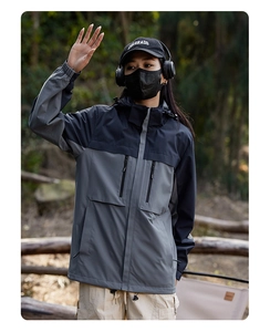 Detail of windproof hiking jacket with detachable hood and functional drawcord waist