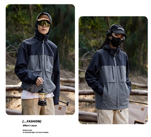 Detail of color-block windproof jacket featuring a detachable hood and multiple pockets