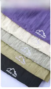 Detail of five colors quick-dry fabric showing mountain embroidery and cool texture