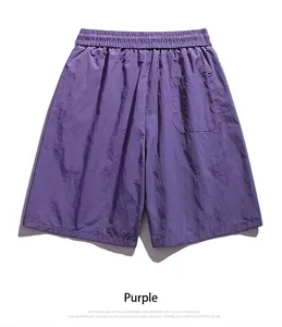 Detail view of purple quick-dry men's shorts with elastic waist and back pocket