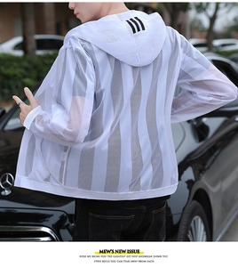 Detail of white mesh sun protection jacket with black stripes on hood in outdoor setting