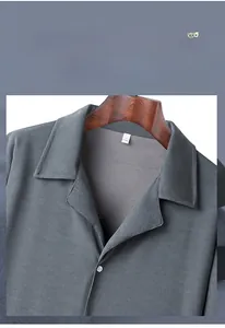 Close-up of gray short-sleeved shirt featuring ribbed texture and buttoned polo collar