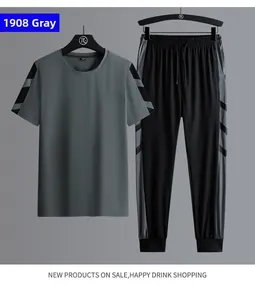 Detail of grey short sleeve sports T-shirt with black stripes and matching track pants