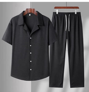 Detail shot of black short sleeve shirt and joggers with waffle texture knit fabric