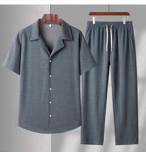 Detail of dark blue-grey short-sleeve shirt and pants with vertical knit texture
