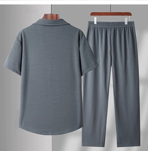 Close-up of men's grey short-sleeve shirt and trousers with vertical waffle texture