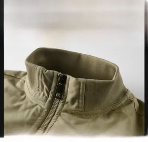 Detail view of khaki military flight jacket featuring a ribbed knit stand collar and zipper