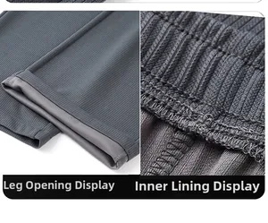 Detailed close-up of dark grey ribbed fabric texture with hem and interior stitching