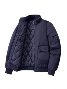 Men's navy bomber jacket with utility pockets and quilted lining in a minimalist style