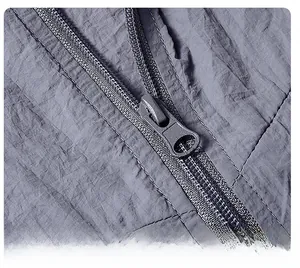 Detailed close-up of a smooth metal zipper on gray ice silk sun protection clothing