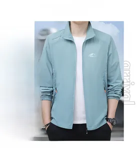 Detail of mint green men's sun protection jacket featuring stand collar and zip pockets