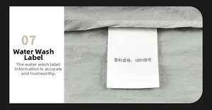 Detail view of the 100% nylon material wash label on the grey sun protection jacket