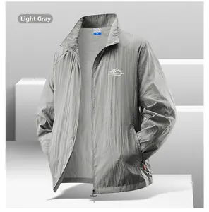 Detail of light gray men's sun protection jacket with mountain logo on white cubes