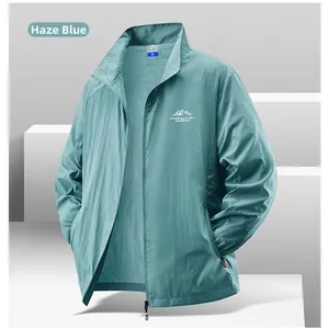 Detail view of haze blue sun protection jacket with mountain chest print and full zipper
