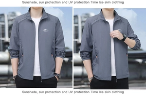 Detail of grey sun protection jacket showing mountain logo and orange zipper accents