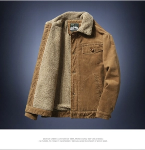 Detail view of khaki corduroy jacket showing thick white sherpa lining and button chest pocket