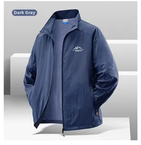 Detail of a lightweight dark gray sun protection jacket with outdoor chest embroidery
