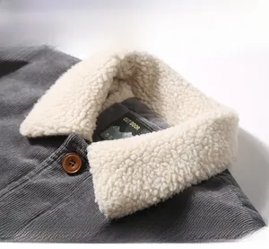 Detail of gray corduroy jacket showing plush lamb wool collar and durable outdoor label
