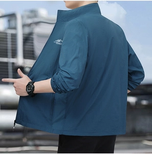 Detail view of navy blue outdoor jacket showing zip collar and adventure print on chest