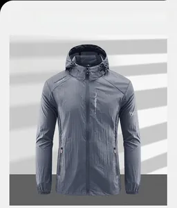 Detail view of lightweight dark gray windbreaker with ripstop texture and hood