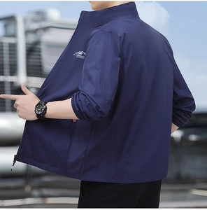 Detail view of navy blue outdoor jacket featuring logo embroidery and windproof cuffs