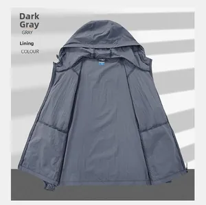 Detail of dark gray sun protection jacket showing the hooded neckline and zipper