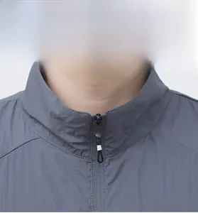 Detailed view of the stand-up collar and black metal zipper on this sun protection jacket