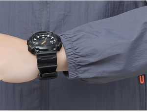 Detailed macro view of an athletic black resin watch with dual digital analog display dial