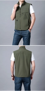 Detail of olive green multi-pocket outdoor vest featuring functional zippers and durable fabric