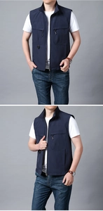 Detail of navy blue multi-pocket outdoor vest with stand collar and metal zipper closure