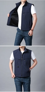 Detail of outdoor utility vest featuring mesh lining and multiple functional zipper pockets