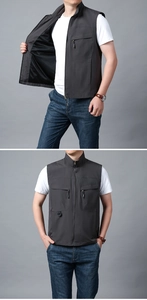 Detail view of dark grey outdoor utility vest with multi-pockets and mesh lining