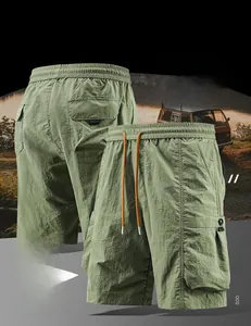 Detail of army green cargo shorts featuring elastic waist, drawstring, and large side pockets