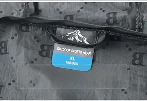 Macro view of neck label with Outdoor Sports Wear text on a gray logo printed jacket