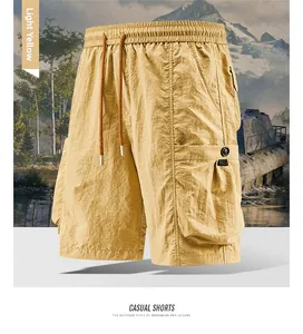Detail of light yellow cargo shorts featuring a large utility pocket and tactical design
